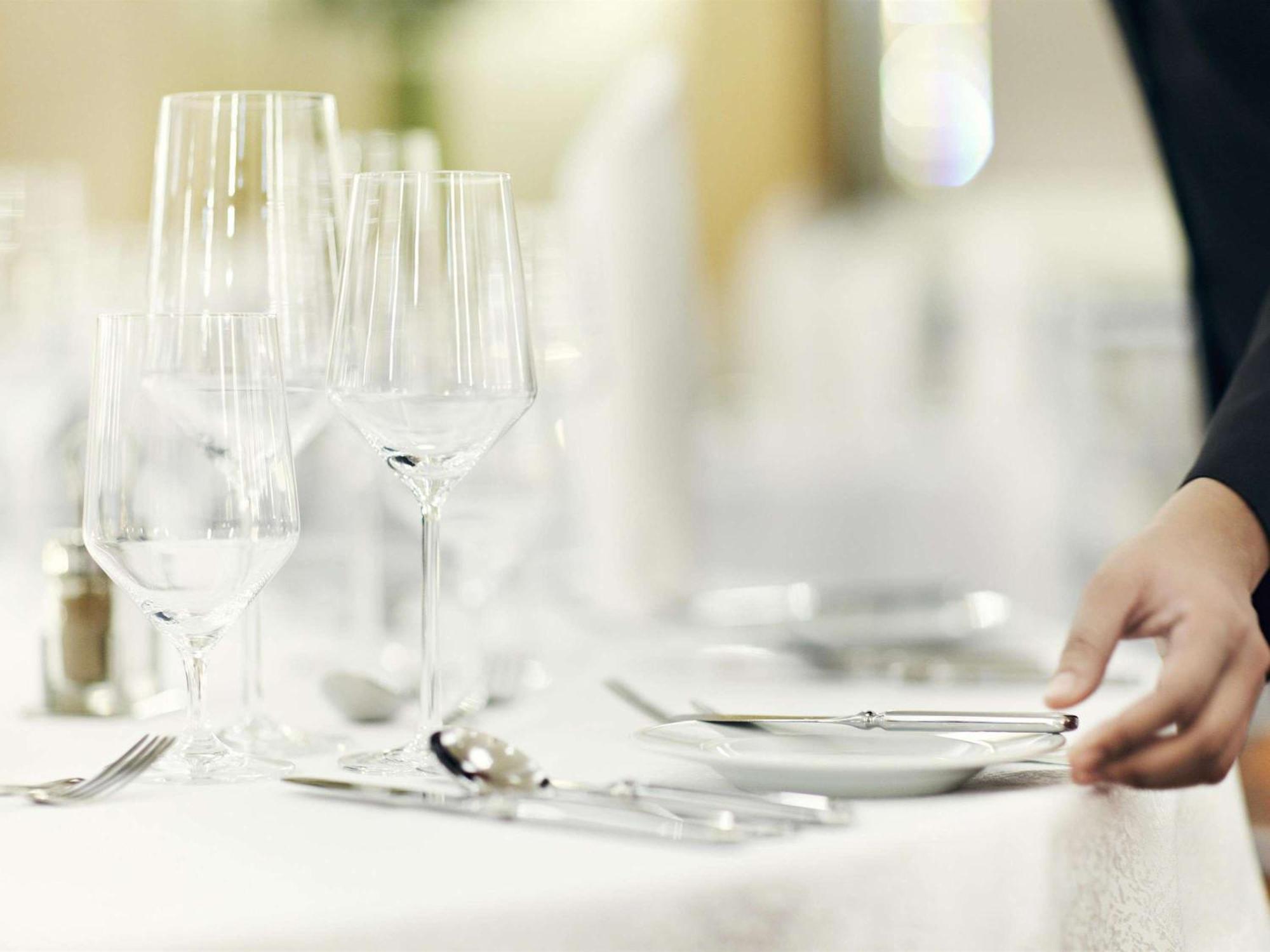 Fairmont Makati Hotell Makati City Eksteriør bilde A waiter sets the table.